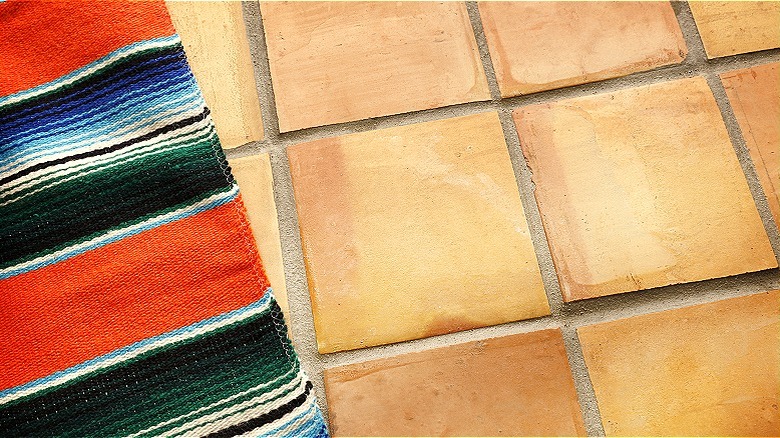 Saltillo tiles with multicolor rug