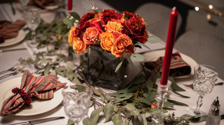 Red and orange flowers on holiday tablescape