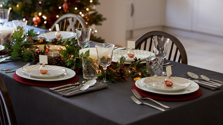 Holiday table setting with white plates and name cards