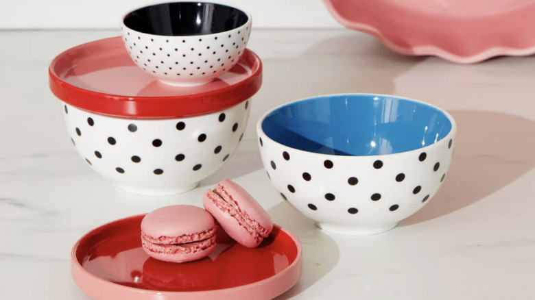 Polka dot bowls and red plates with macarons.