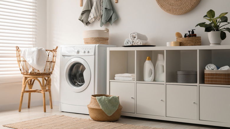laundry room with dishwasher and storage shelves