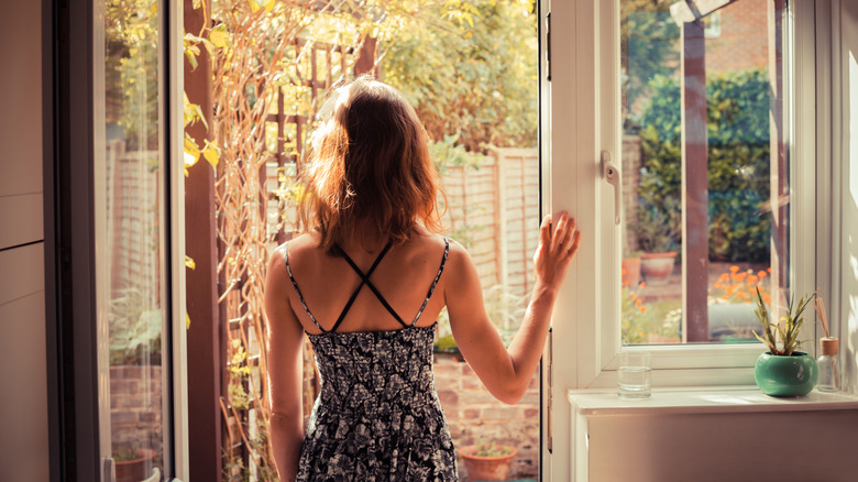 woman standing at back door