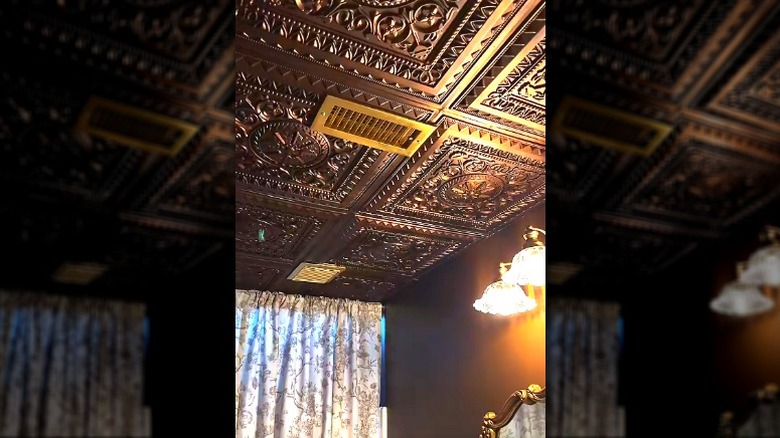 Room with metallic tin ceiling tiles.