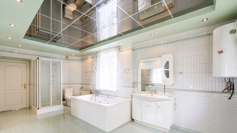 A large, white bathroom with a grid mirror ceiling.