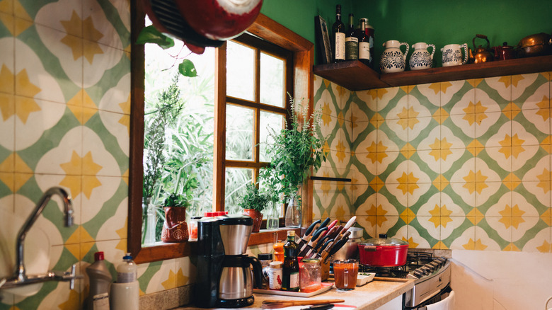 A retro kitchen with a geometric tile backsplash.
