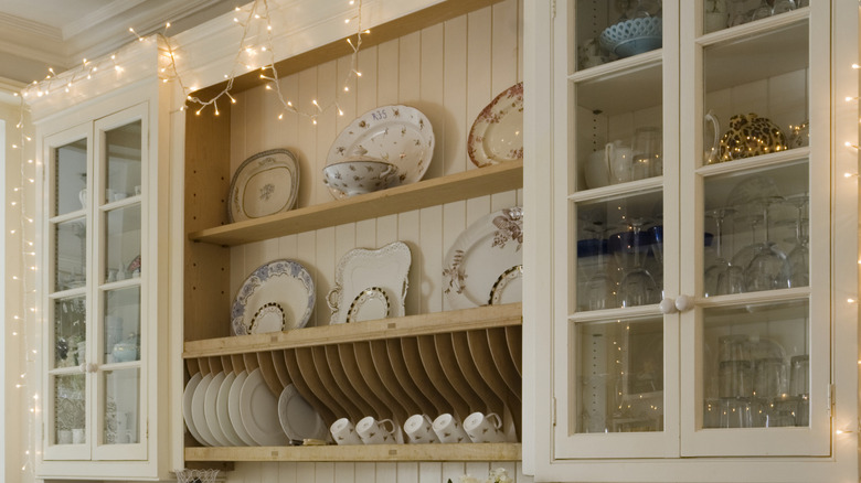 Open shelving and glass panel cabinets.