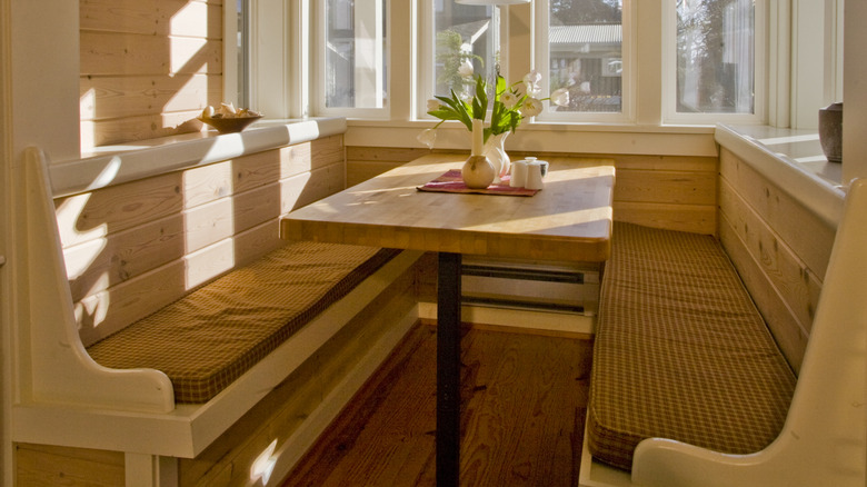 A breakfast nook with a window in a cottage-style home.