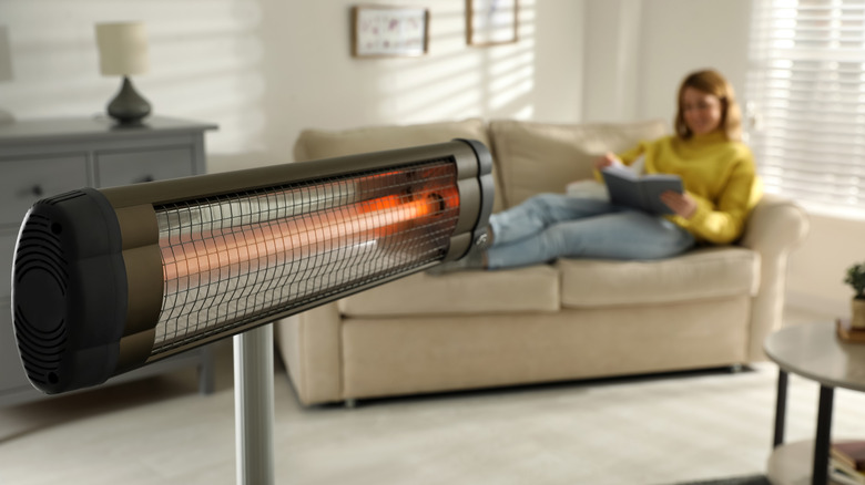 Person sitting with heater