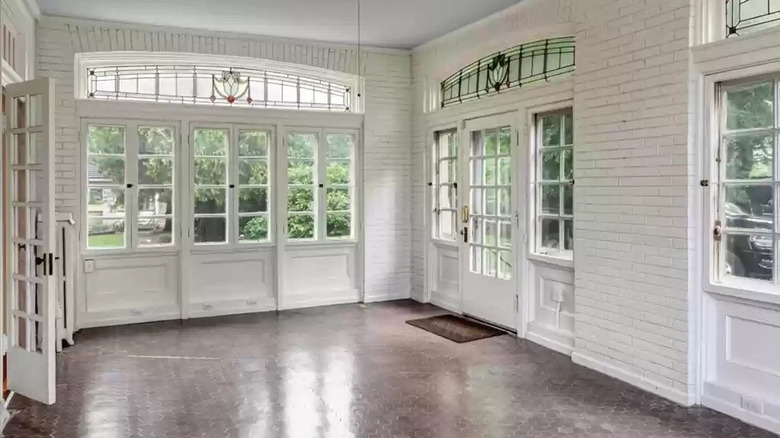 Sunroom with white brick walls