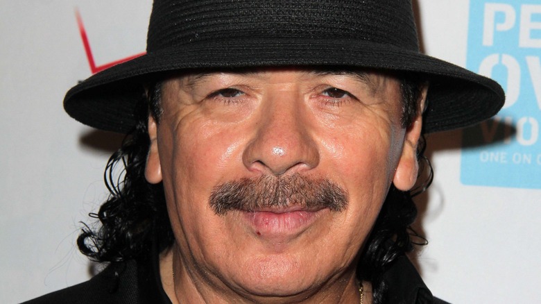 Carlos Santana wearing hat