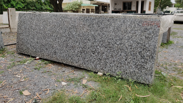 A gray granite countertop slab outside
