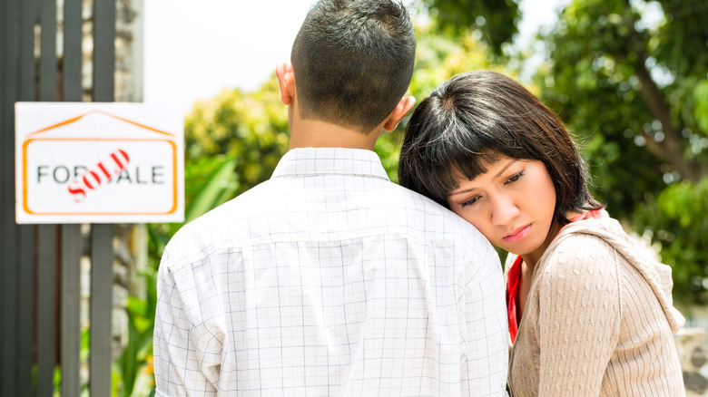 Sad woman leaning on man