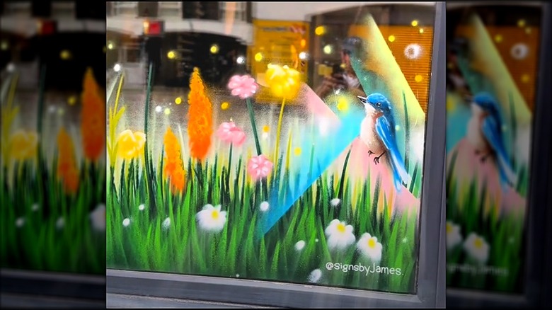 Window painting of bluebird in field