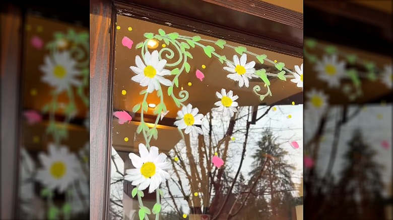 Daisies painted in the corner of a window