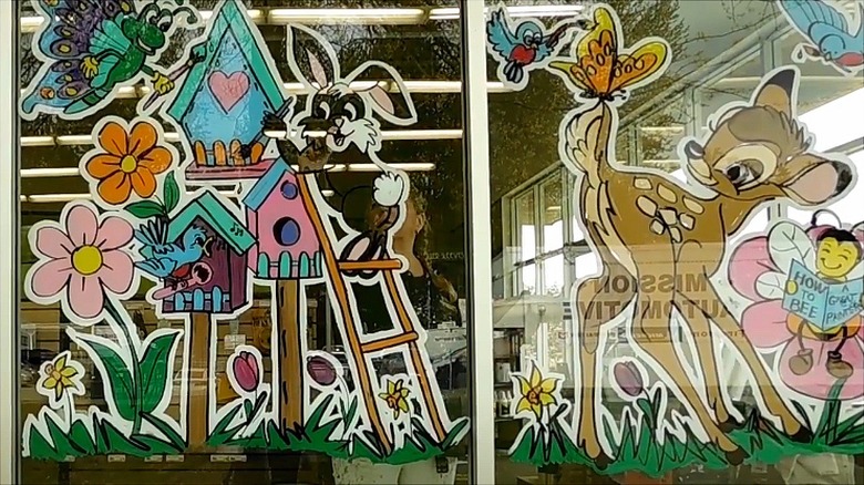 Deer and rabbit painted onto large window as part of spring display