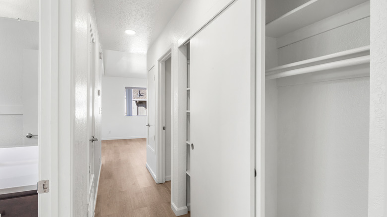 Hallway closet with white sliding doors installed