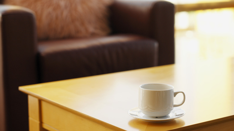 coffee mug and plate on living room coffee table