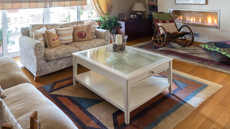 Glass coffee table with accessories in living room