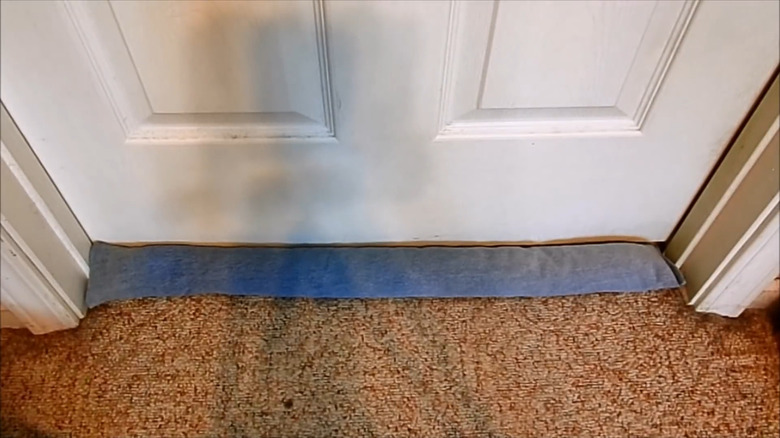 an affordable diy draft stopper made from old denim jeans