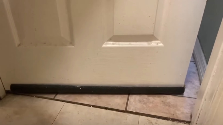 a piece of pipe insulation used as a door draft stopper