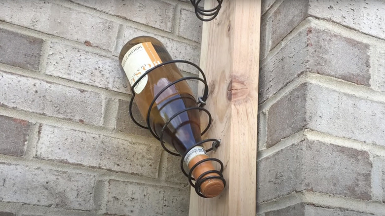 Bottle of Moscato upside-down in a DIY wine rack made from a box spring