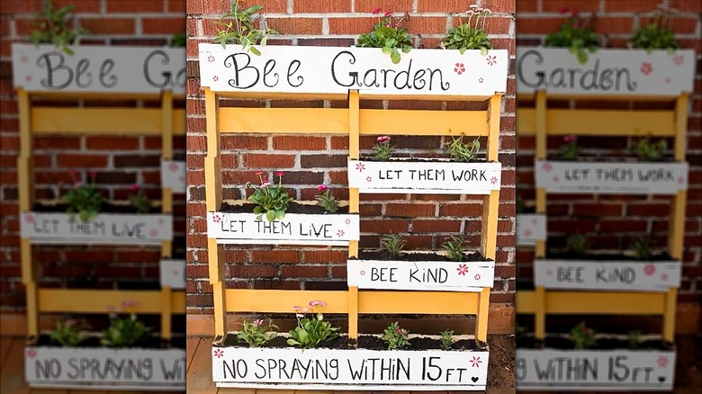 One pallet converted into a planter holds flowers to attract bees and other pollinators.