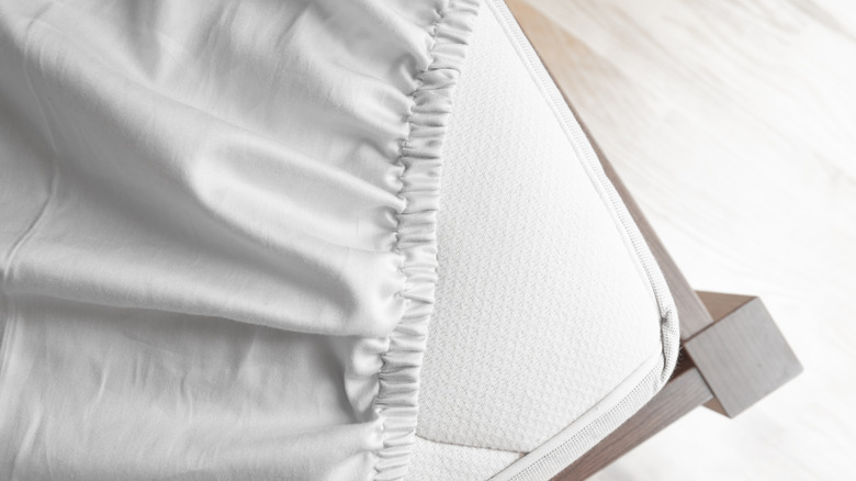 Fitted sheet on edge of mattress