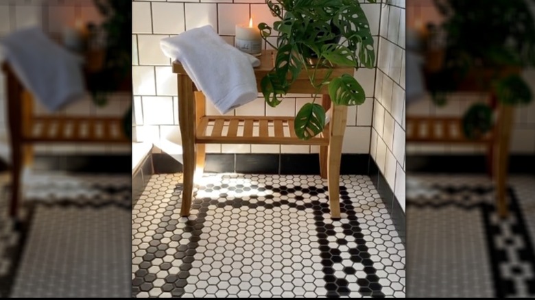 Art Deco inspired shower floor with black and white mosaic hex tiles