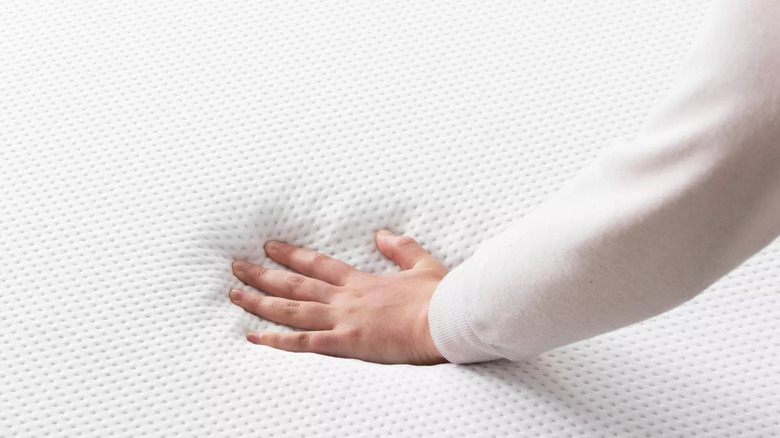 Purple mattress with hand