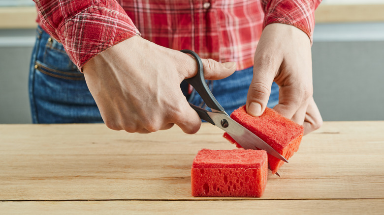 Man cuts sponge into smaller pieces.
