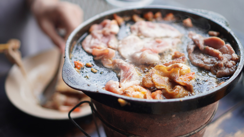 A cast iron skillet containing bacon