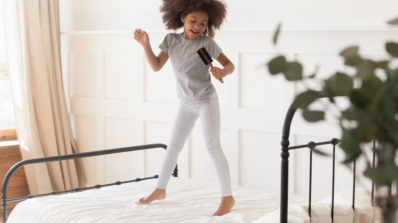 Child jumping on bed