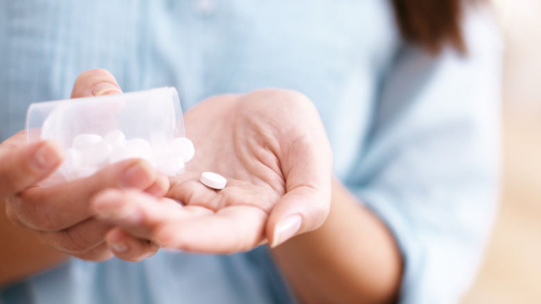 pouring Aspirin into one hand
