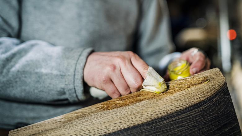 man using beeswax as polish