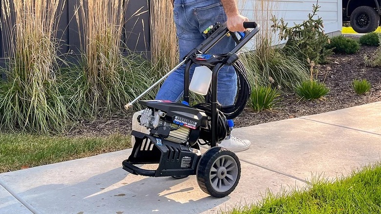 Man moving an AR Blue Clean pressure water
