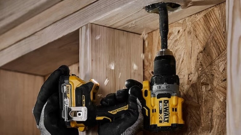 The Dewalt 20V XR cordless drill driver drilling through framing