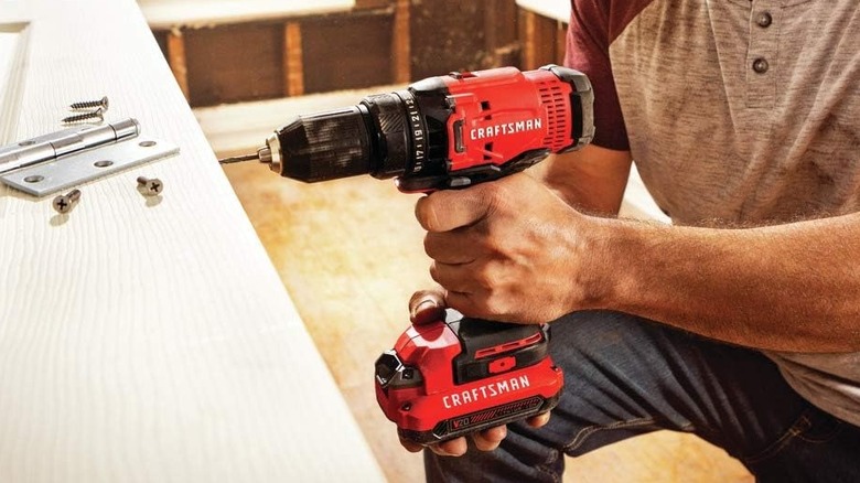 The Craftsman 20V drill driver being used to fit a door hinge