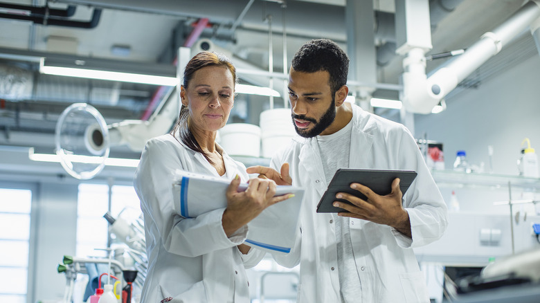 A female and male engineer work together in a lab.