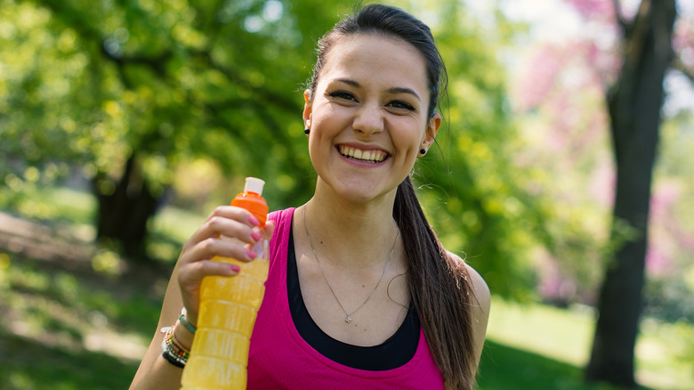 Smiling woman with sport drink
