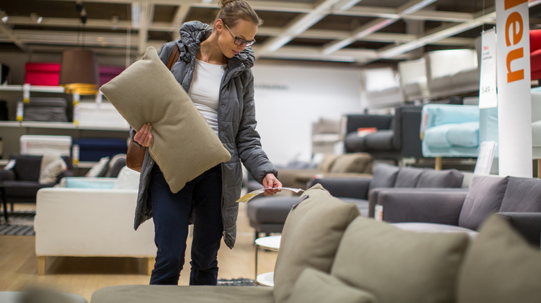 person looking at IKEA couches in a store