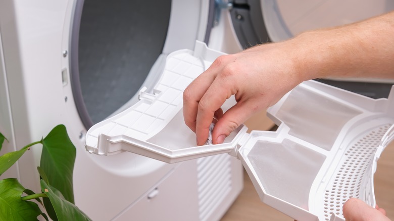 hand removing dryer lint