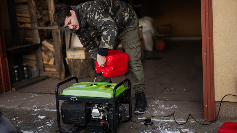 Man pouring fuel into gas-powered generator