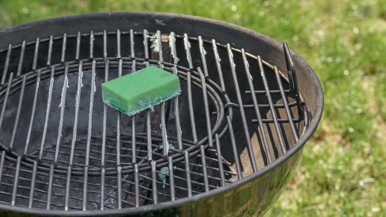 Charcoal grill in the process of being cleaned.