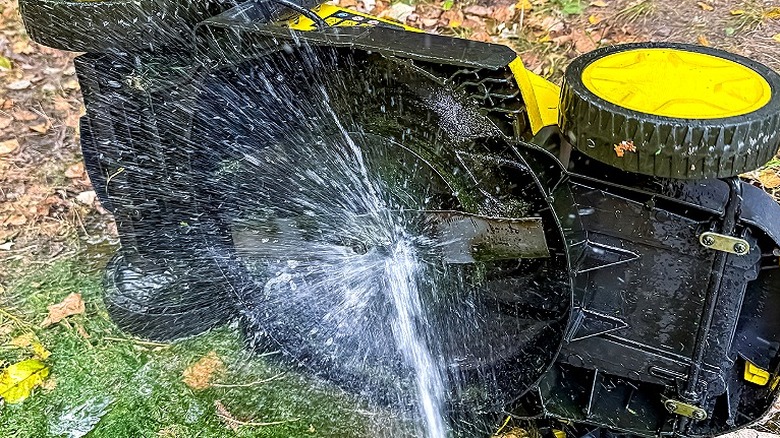 Washing a mower deck with a garden hose