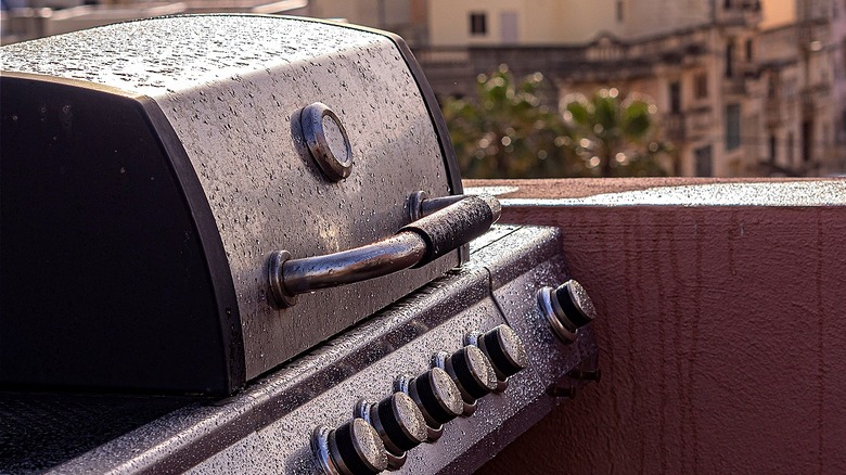 Closed gas grill with raindrops covering it