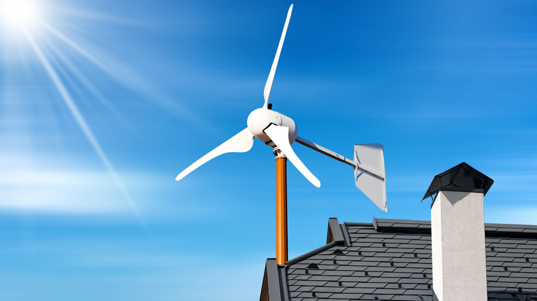 Close-up of a small wind turbine on the top of a roof of a house