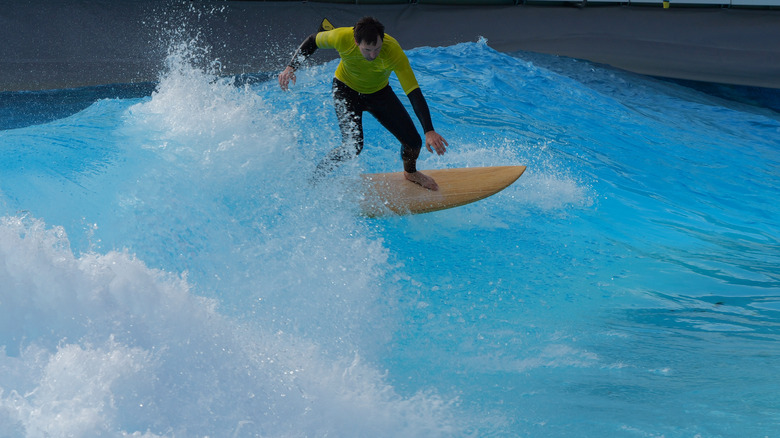 Person surfing in a wave pool