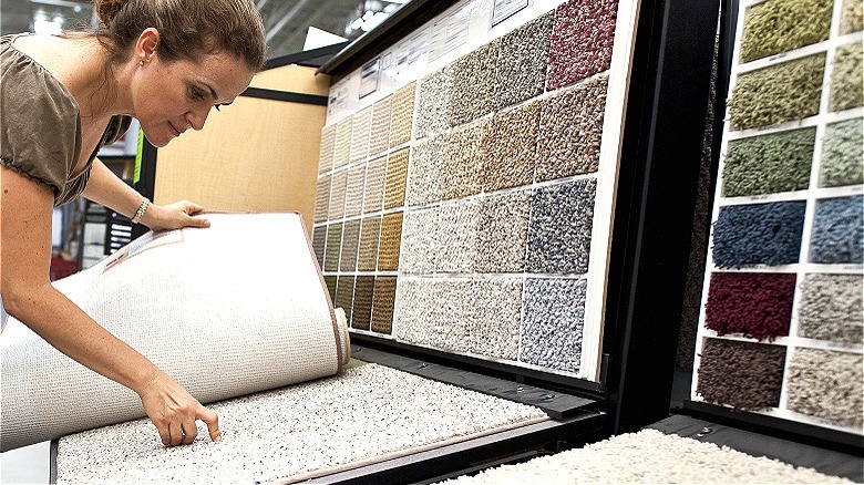 Person picking carpet at store