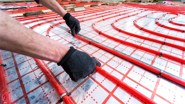 Person installing radiant floor heating