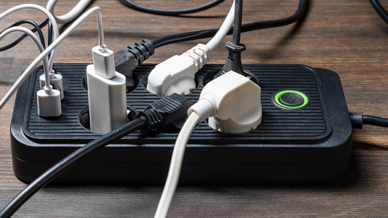 an extension cord with many devices plugged into it
